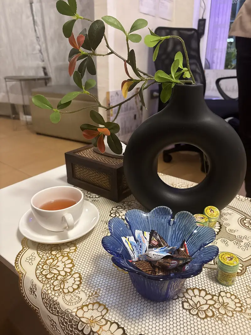 Tea, sweets and Thai balm on the table